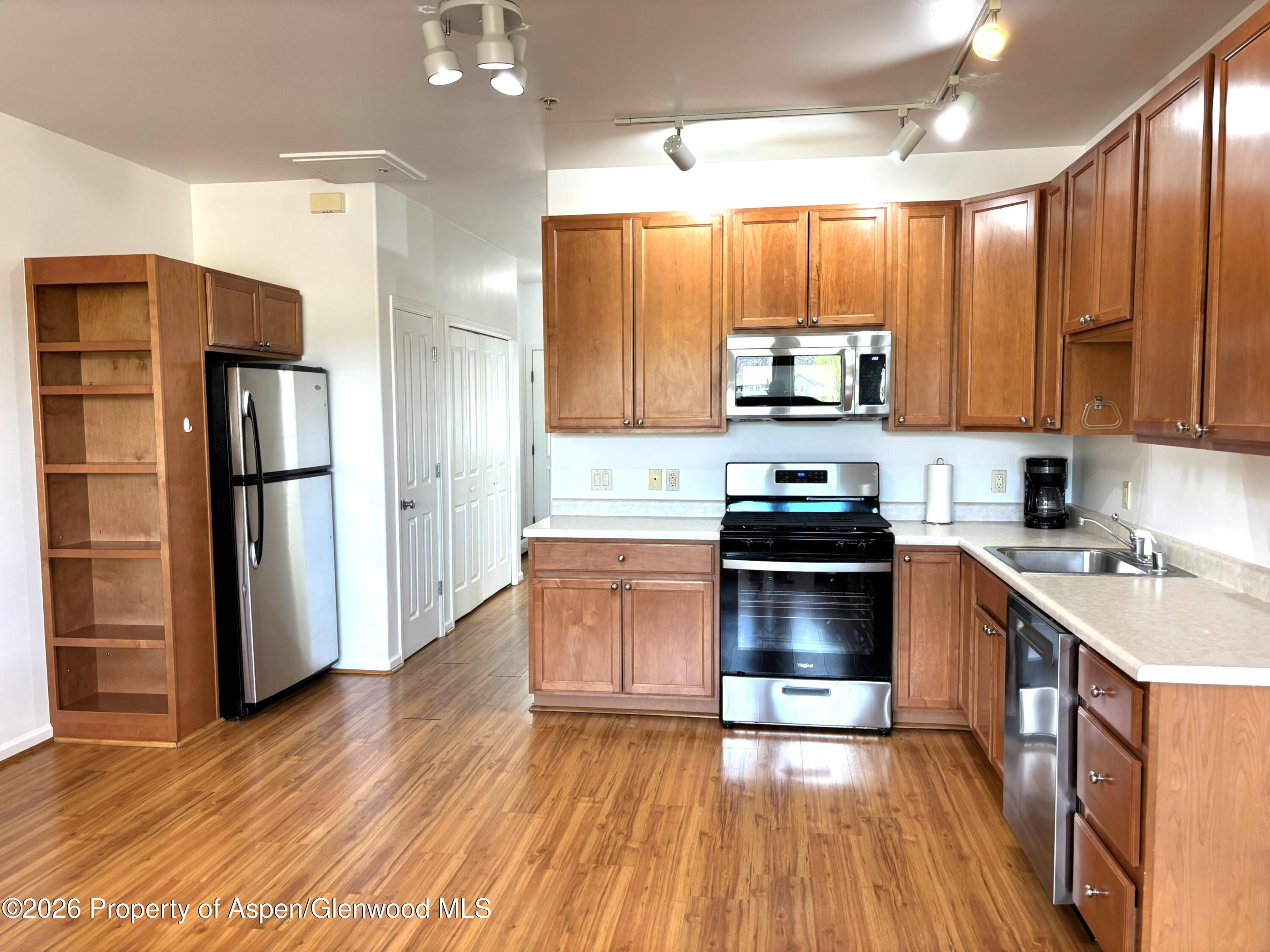 712 Lakeside Drive Basalt, CO 81621 - Photo 5 of 21 a kitchen with granite countertop a refrigerator and a stove top oven