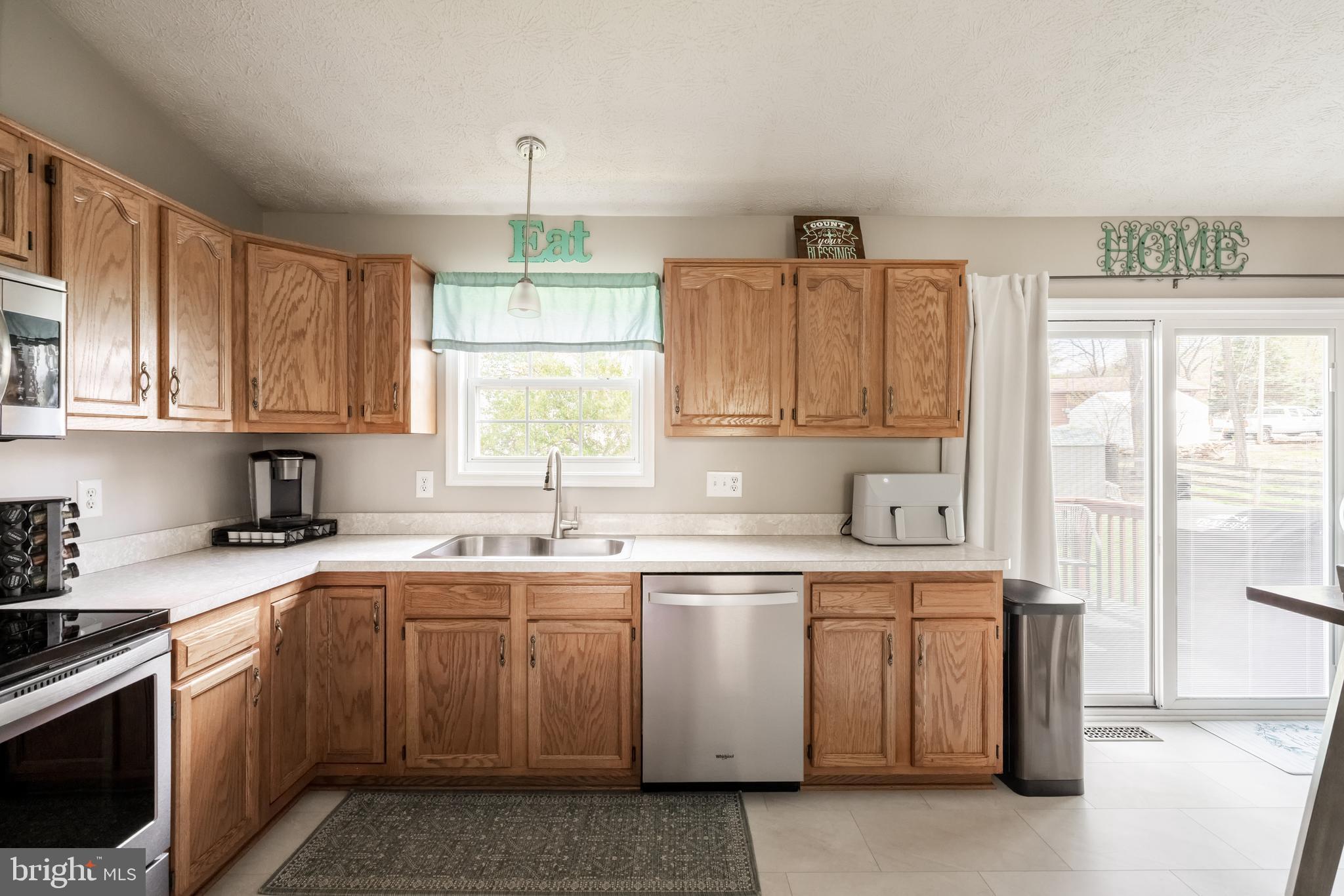 143 Club House Road Front Royal, VA 22630 - Photo 13 of 38 a kitchen with a sink stove and cabinets