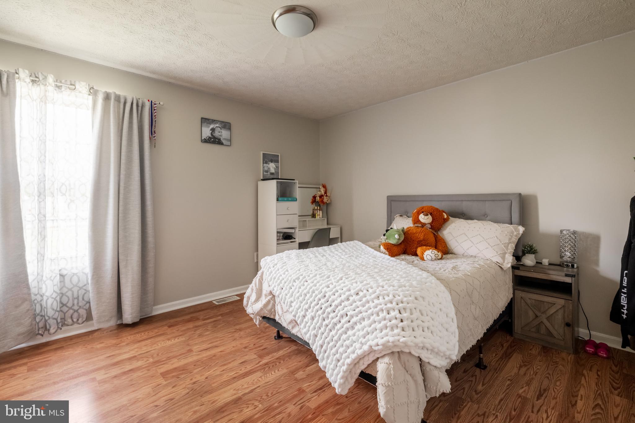 143 Club House Road Front Royal, VA 22630 - Photo 15 of 38 a bedroom with a bed and wooden floor