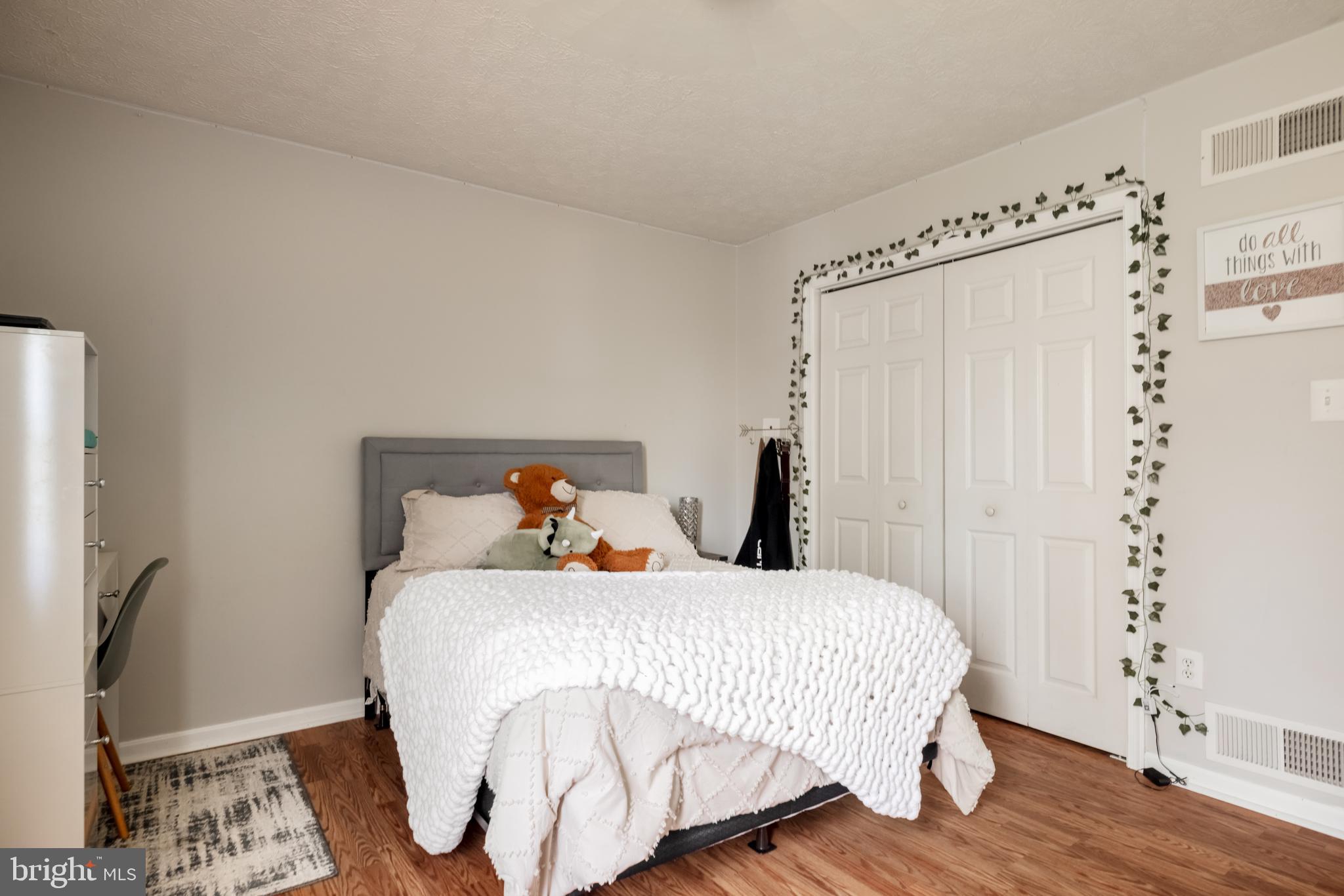 143 Club House Road Front Royal, VA 22630 - Photo 16 of 38 a bedroom with a bed and wooden floor