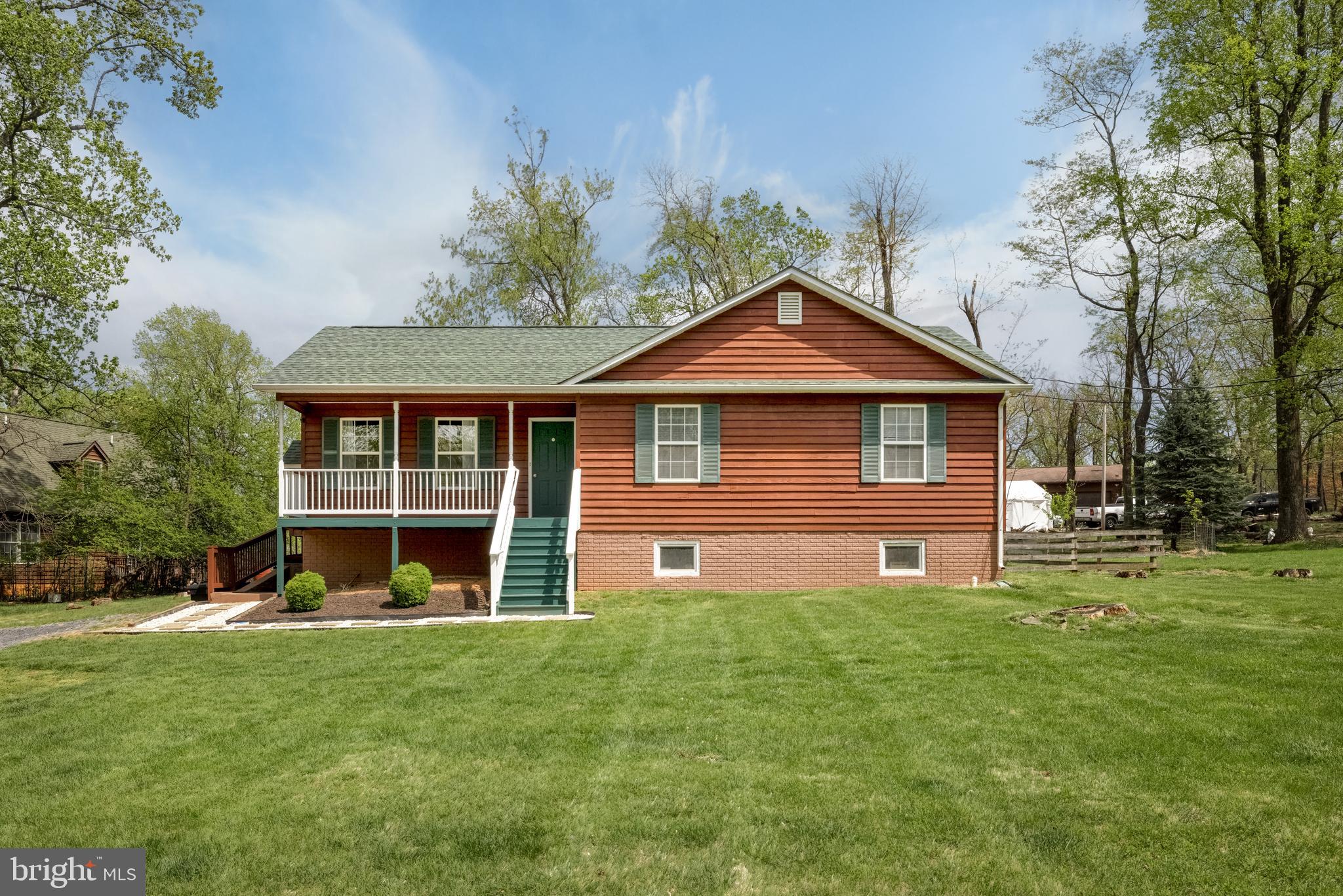 143 Club House Road Front Royal, VA 22630 - Photo 2 of 38 a front view of a house with a yard