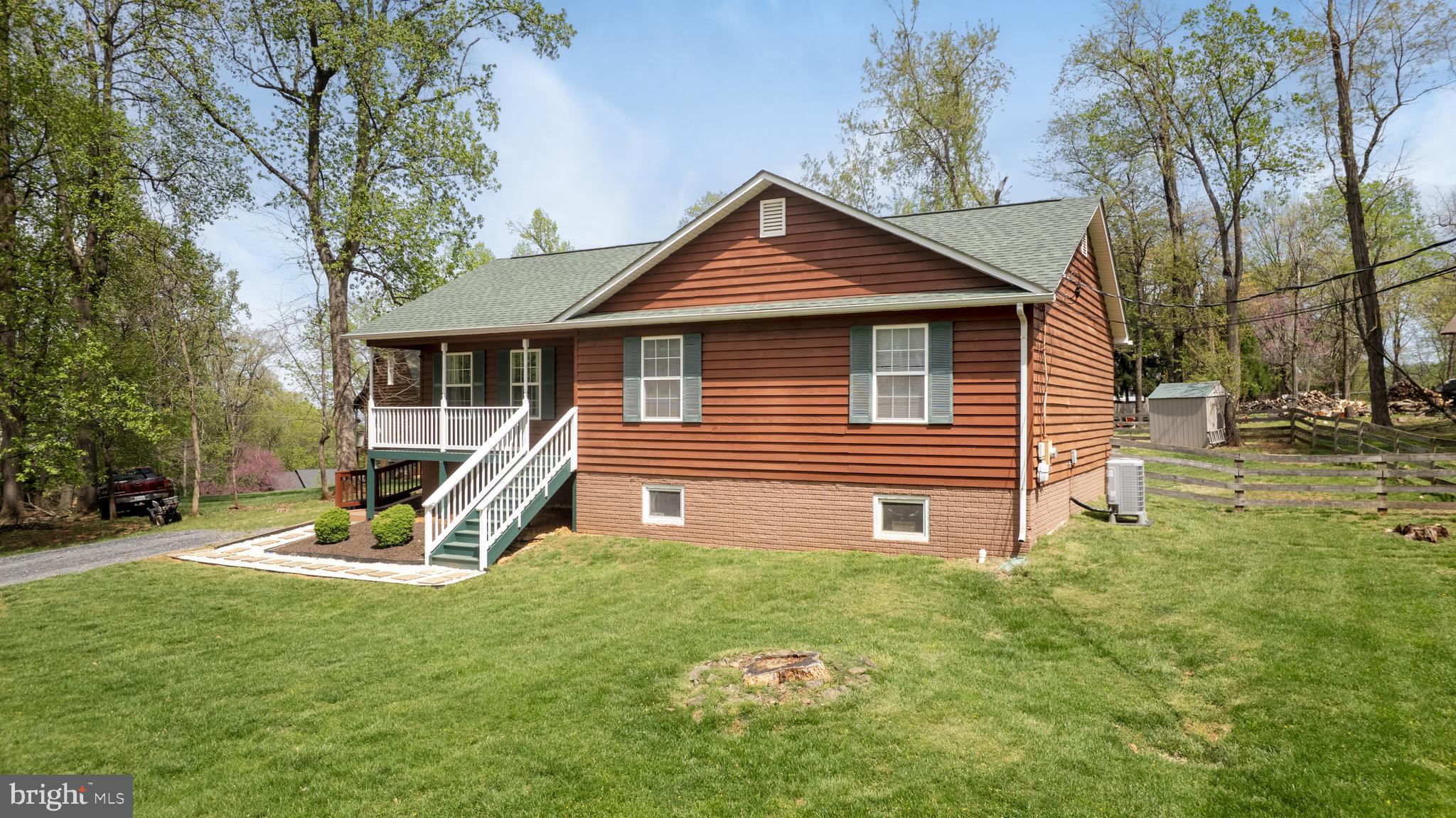 143 Club House Road Front Royal, VA 22630 - Photo 4 of 38 a view of a house with a yard porch and wooden fence