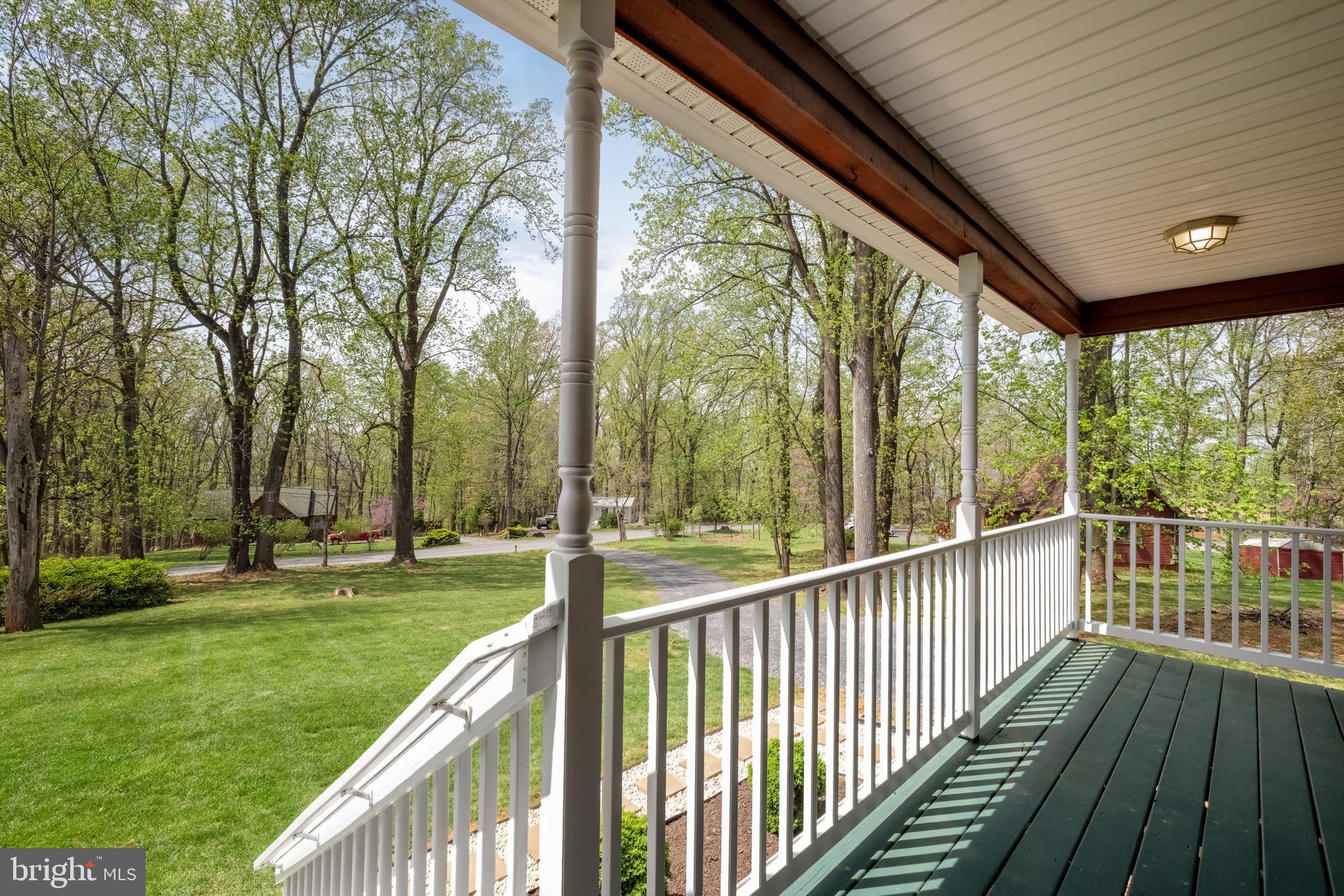 143 Club House Road Front Royal, VA 22630 - Photo 5 of 38 a view of a deck with a big yard and potted plants