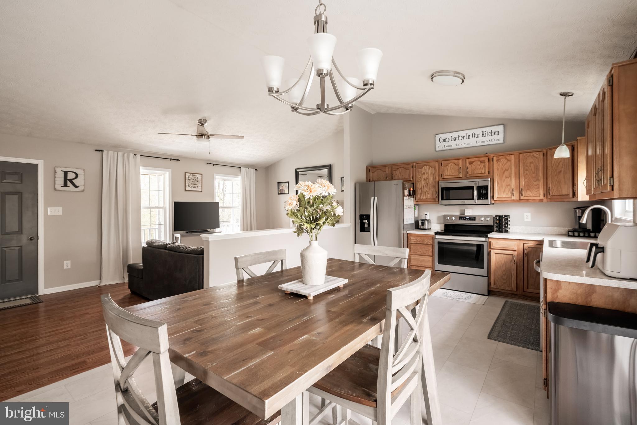 143 Club House Road Front Royal, VA 22630 - Photo 10 of 38 a kitchen with stainless steel appliances granite countertop a dining table and chairs in it