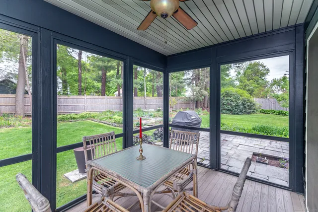 a view of a patio with a table chairs and a backyard