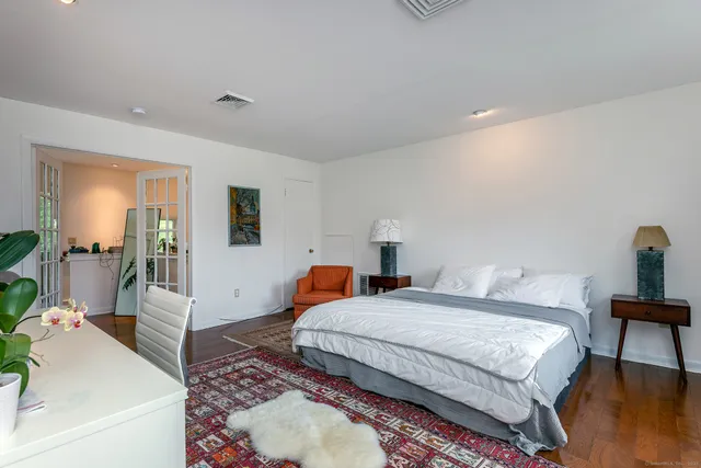 a bedroom with two beds and a table