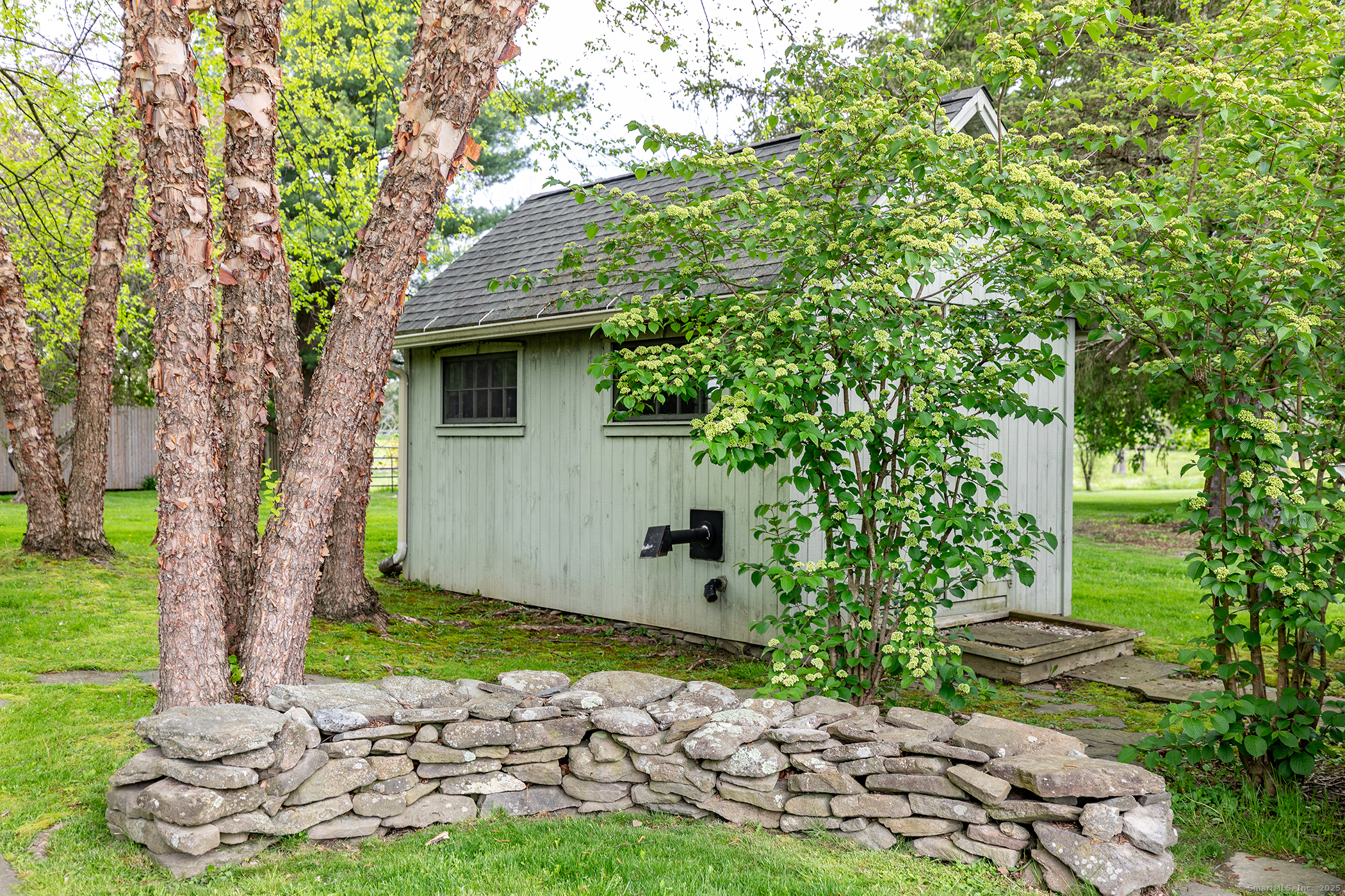 17 Rhynus Road Sharon, CT 06069 - Photo 24 of 30 a view of a backyard with plants and large tree