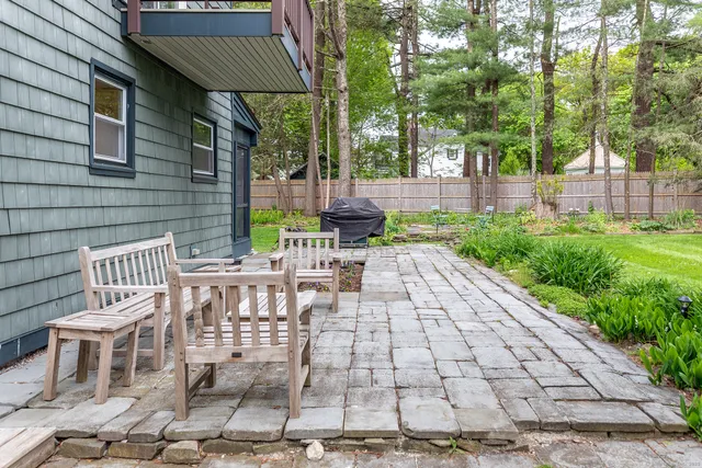 a view of a patio with table and chairs with wooden fence and plants