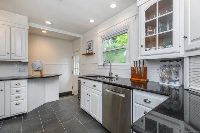 a kitchen with stainless steel appliances granite countertop a stove and a sink