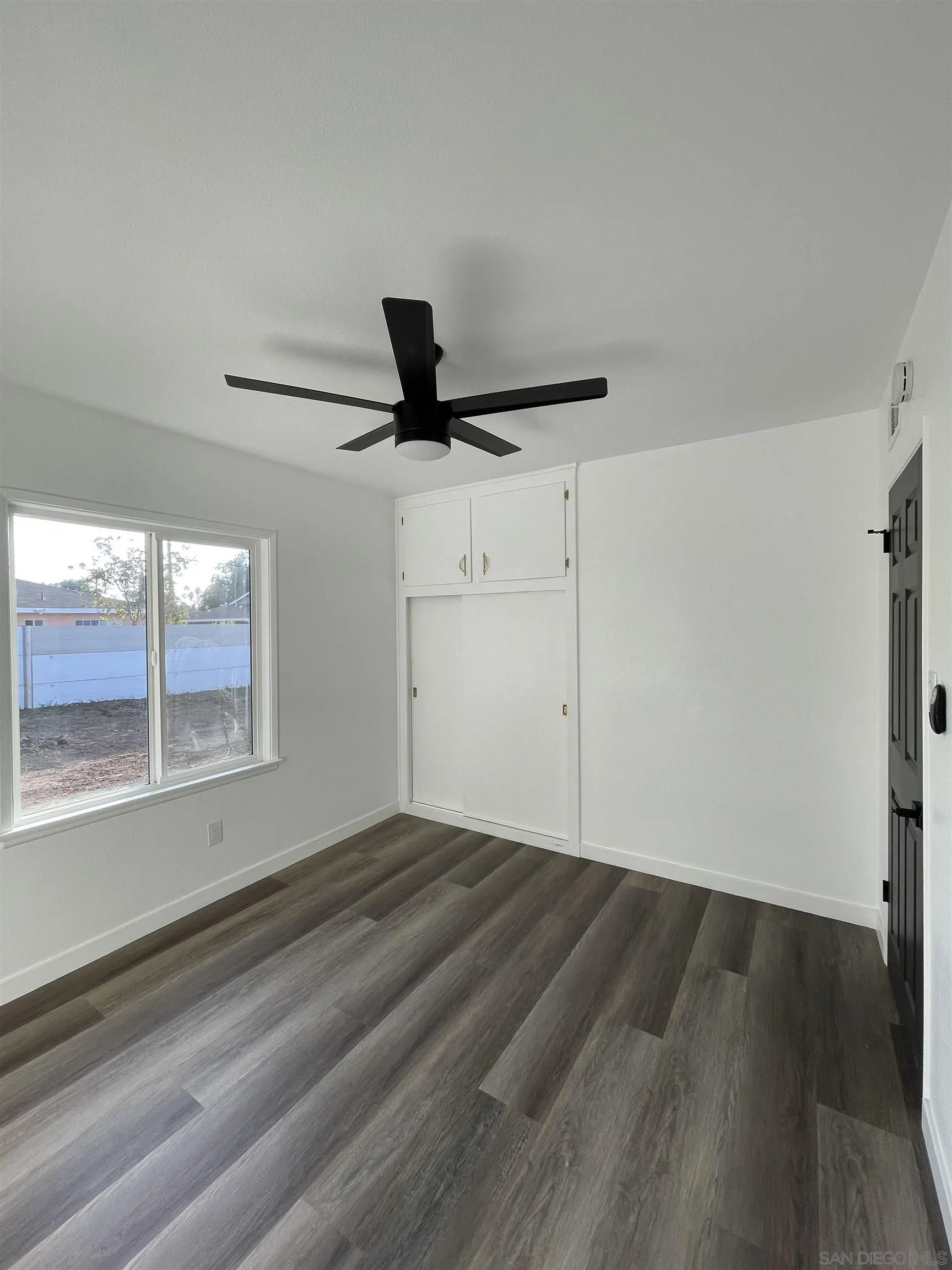 1976 3rd Street Riverside, CA 92507 - Photo 17 of 43 a view of empty room with wooden floor and fan