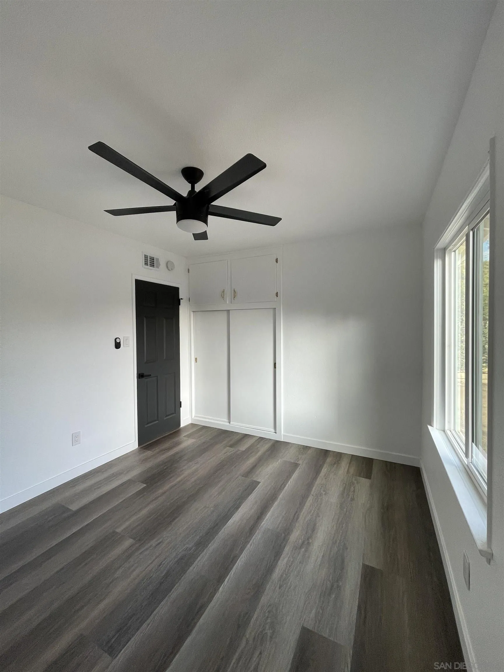 1976 3rd Street Riverside, CA 92507 - Photo 18 of 43 wooden floor in an empty room with a window
