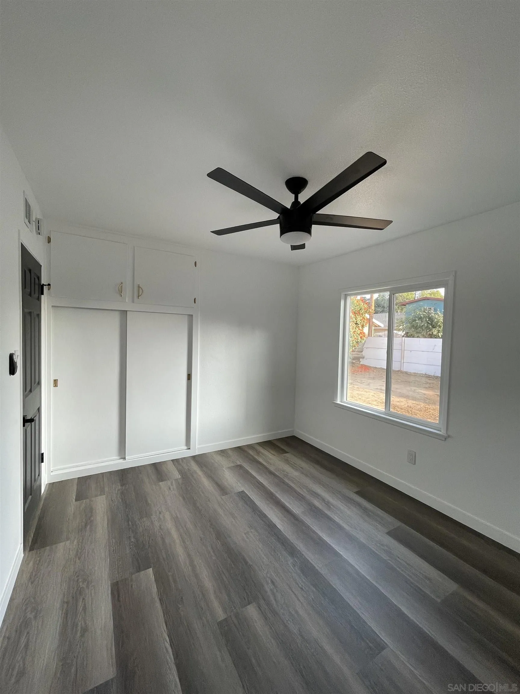 1976 3rd Street Riverside, CA 92507 - Photo 19 of 43 wooden floor in an empty room with a window