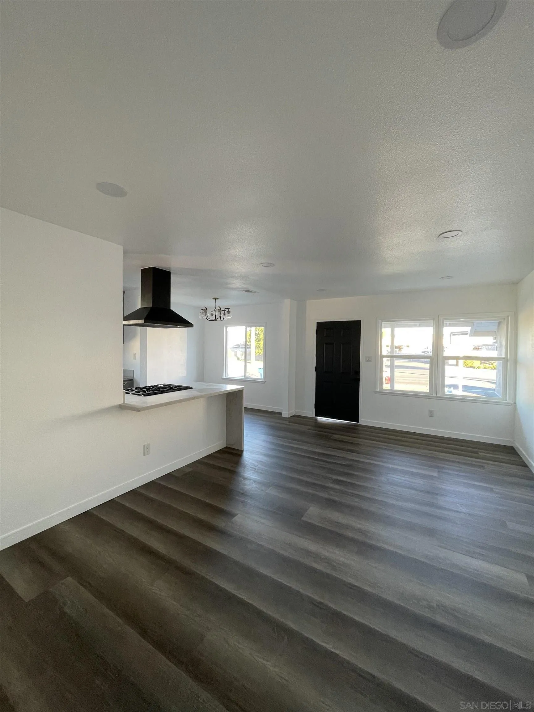 1976 3rd Street Riverside, CA 92507 - Photo 8 of 43 a view of an empty room with a window and wooden floor