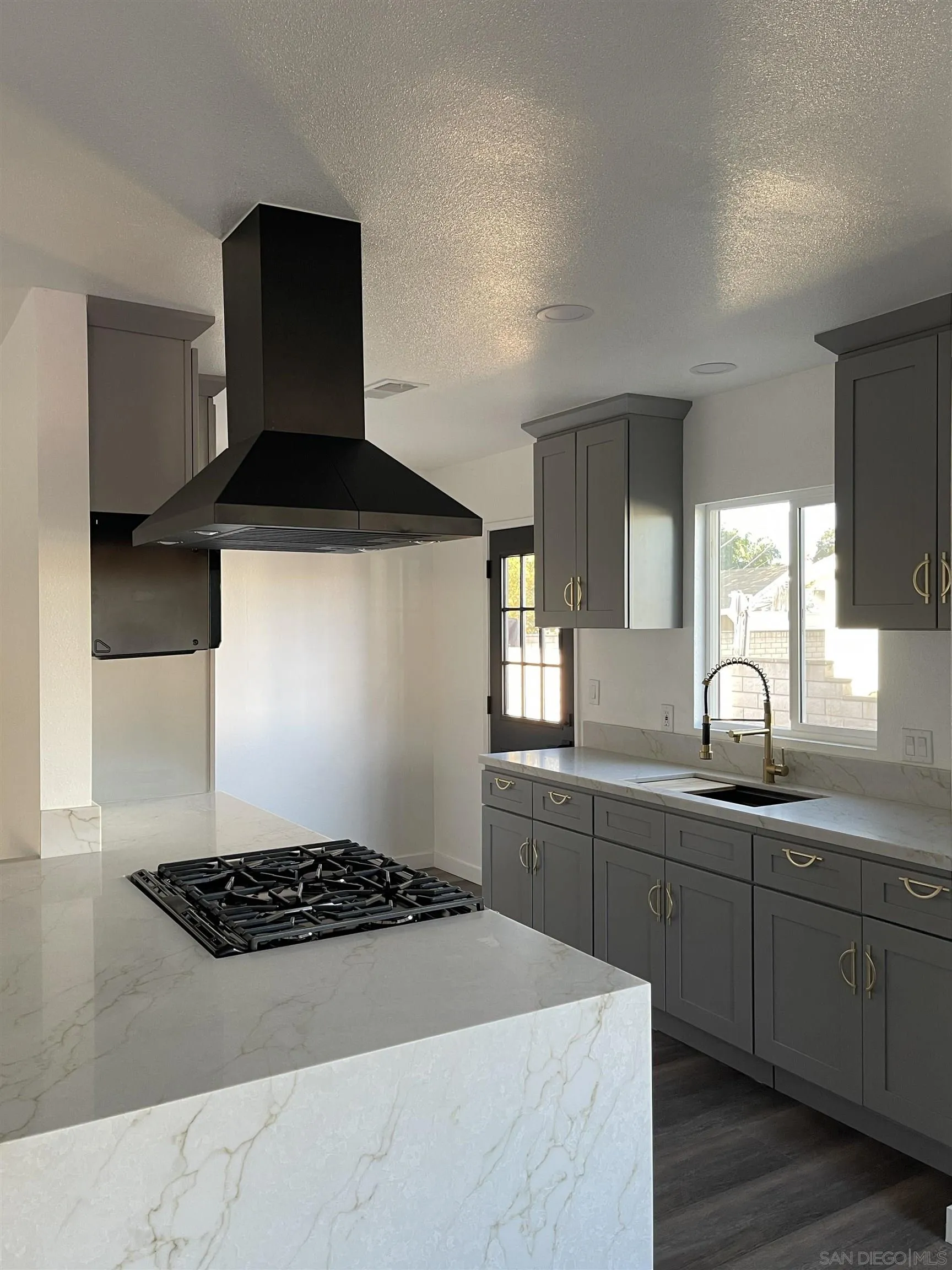 1976 3rd Street Riverside, CA 92507 - Photo 10 of 43 a kitchen with a sink a stove and cabinets