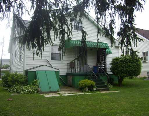 34 Rumbaugh Avenue Mount Pleasant, PA 15666 - Photo 15 of 17 Exterior Back. GREAT BACK YARD AND REAR VIEW OF HOME WITH COVERED BACK PORCH AND ENTRANCE TO BASEMENT