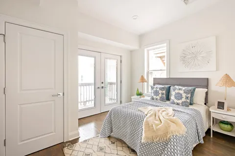 a bedroom with a bed and a window