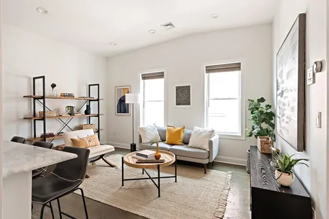 a living room with furniture and wooden floor