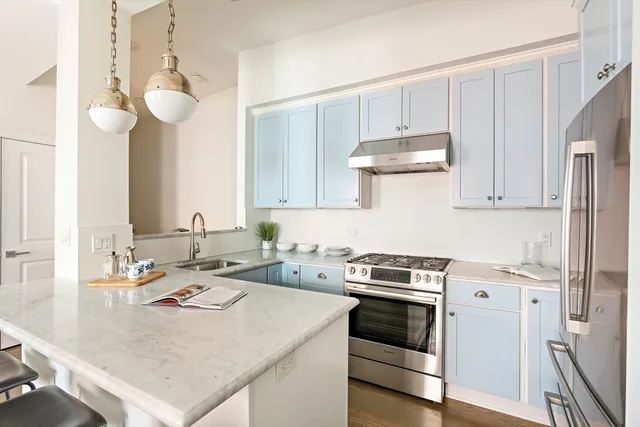 a kitchen with a stove a sink and cabinets