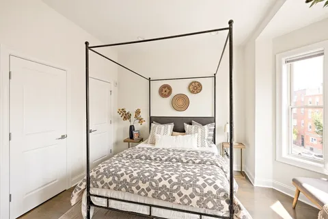 a bed room with a bed and a window