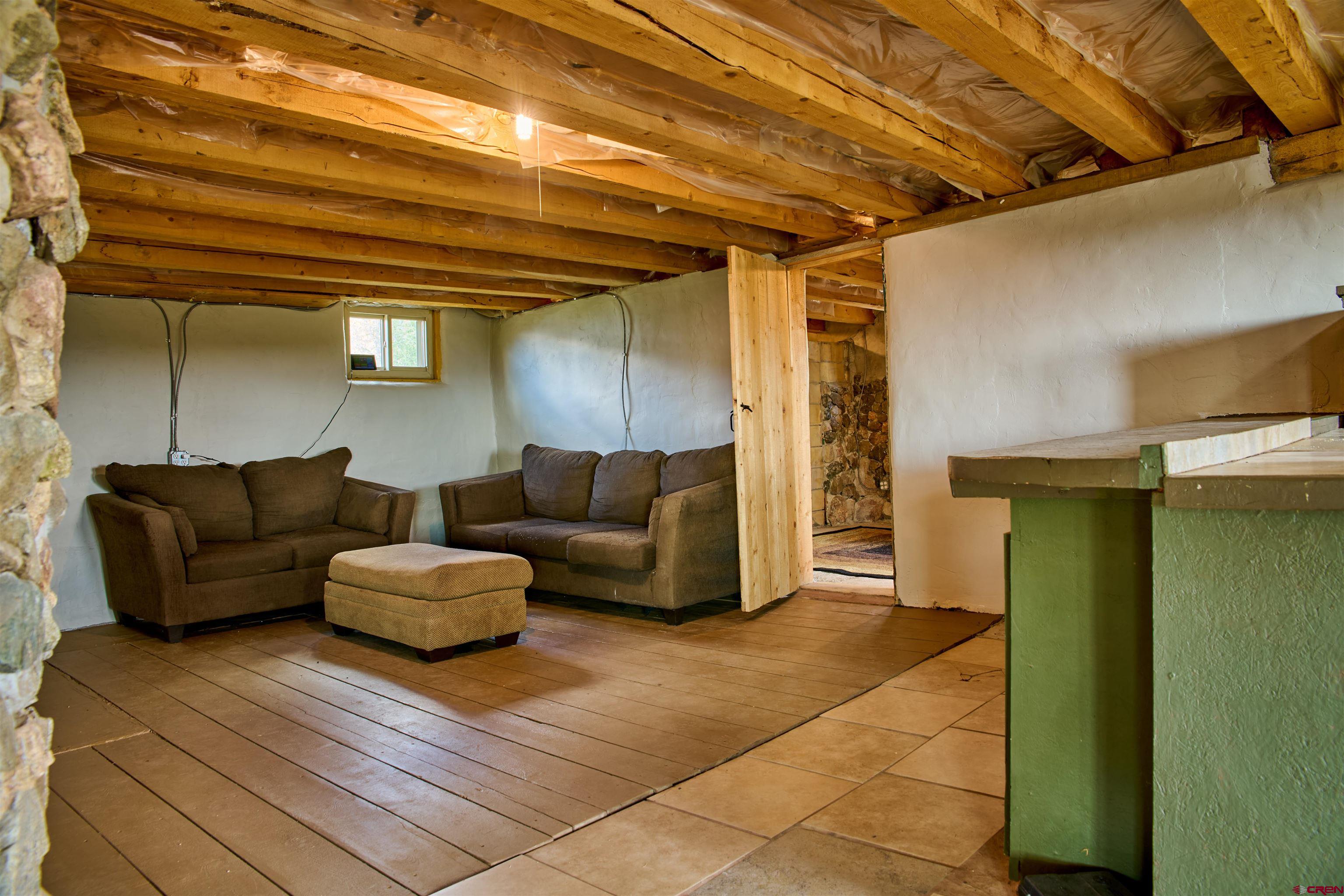1380 Dunn Road Fort Garland, CO 81133 - Photo 15 of 45 a living room with furniture and a table