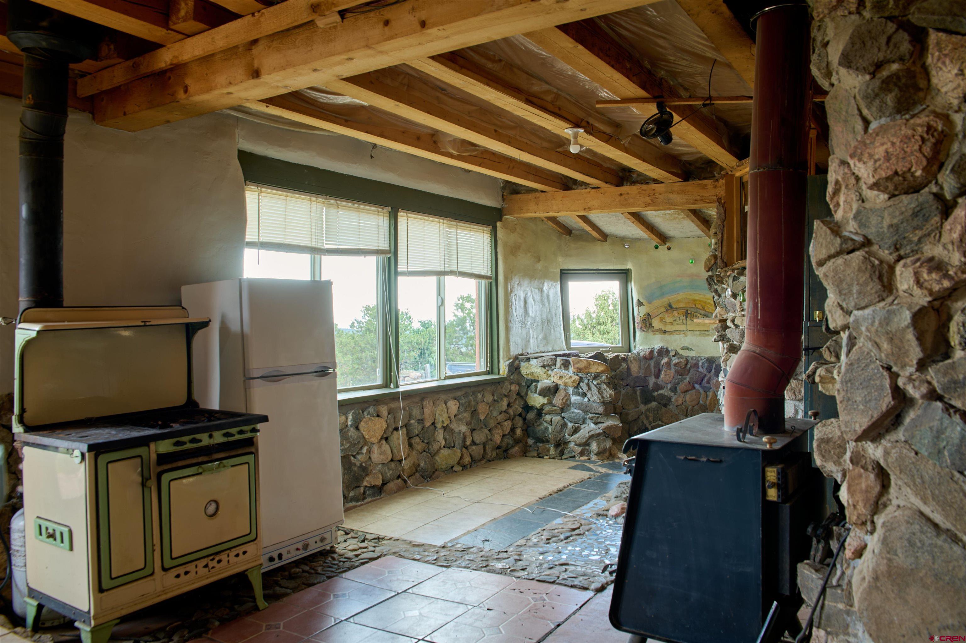 1380 Dunn Road Fort Garland, CO 81133 - Photo 5 of 45 a living room with furniture and a flat screen tv