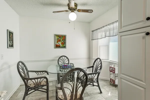 a view of a dining room with furniture and a chandelier