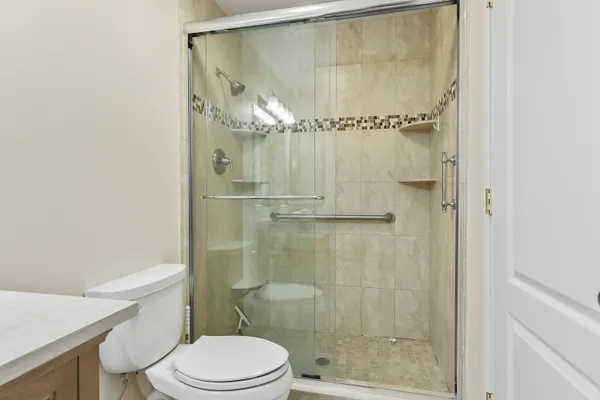 a bathroom with a shower a toilet and a sink