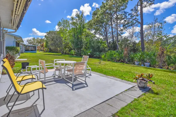 a view of a chairs and table in the garden