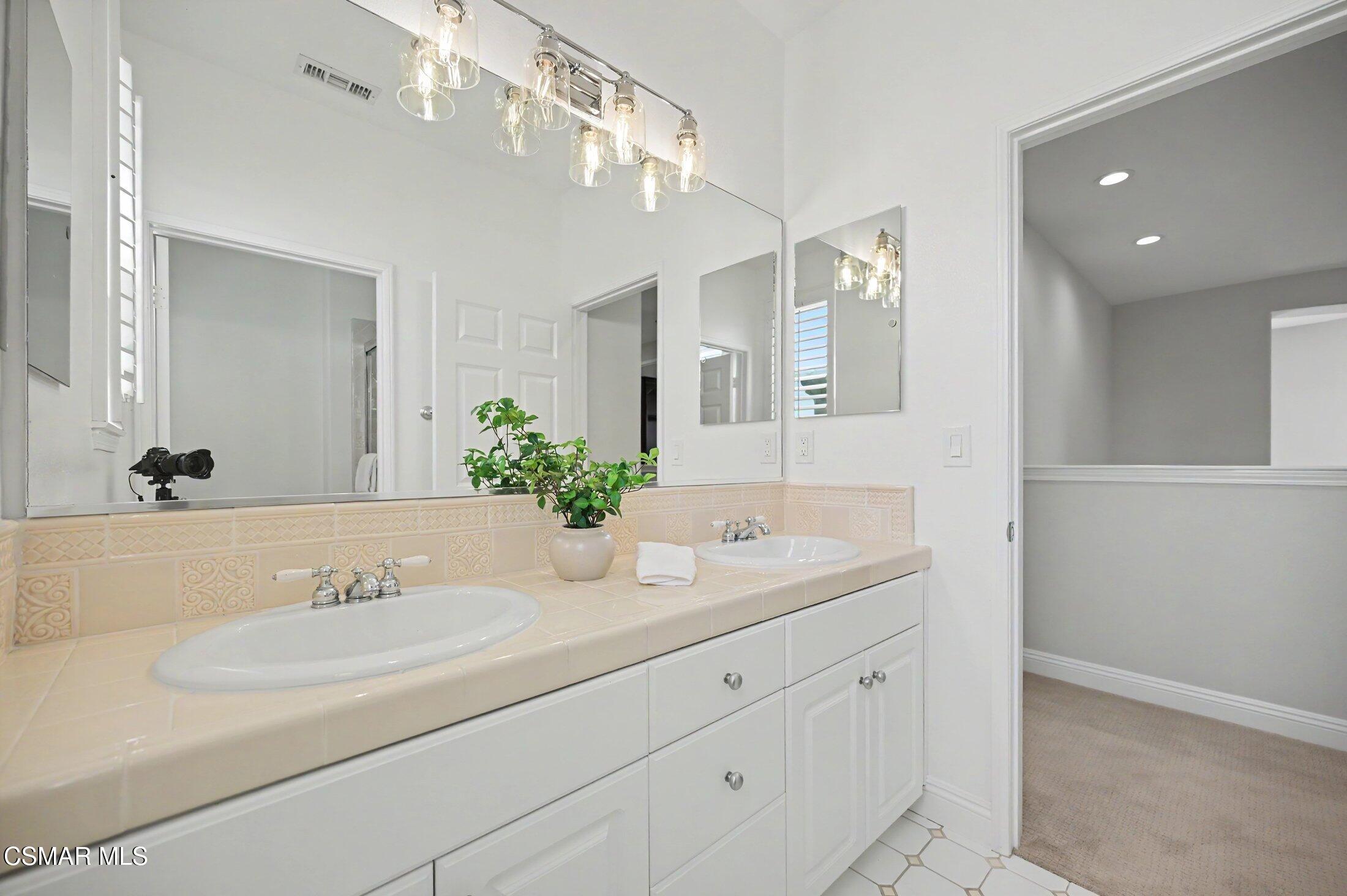 20800 Sardinia Way Porter Ranch, CA 91326 - Photo 39 of 57 a bathroom with a sink and a mirror