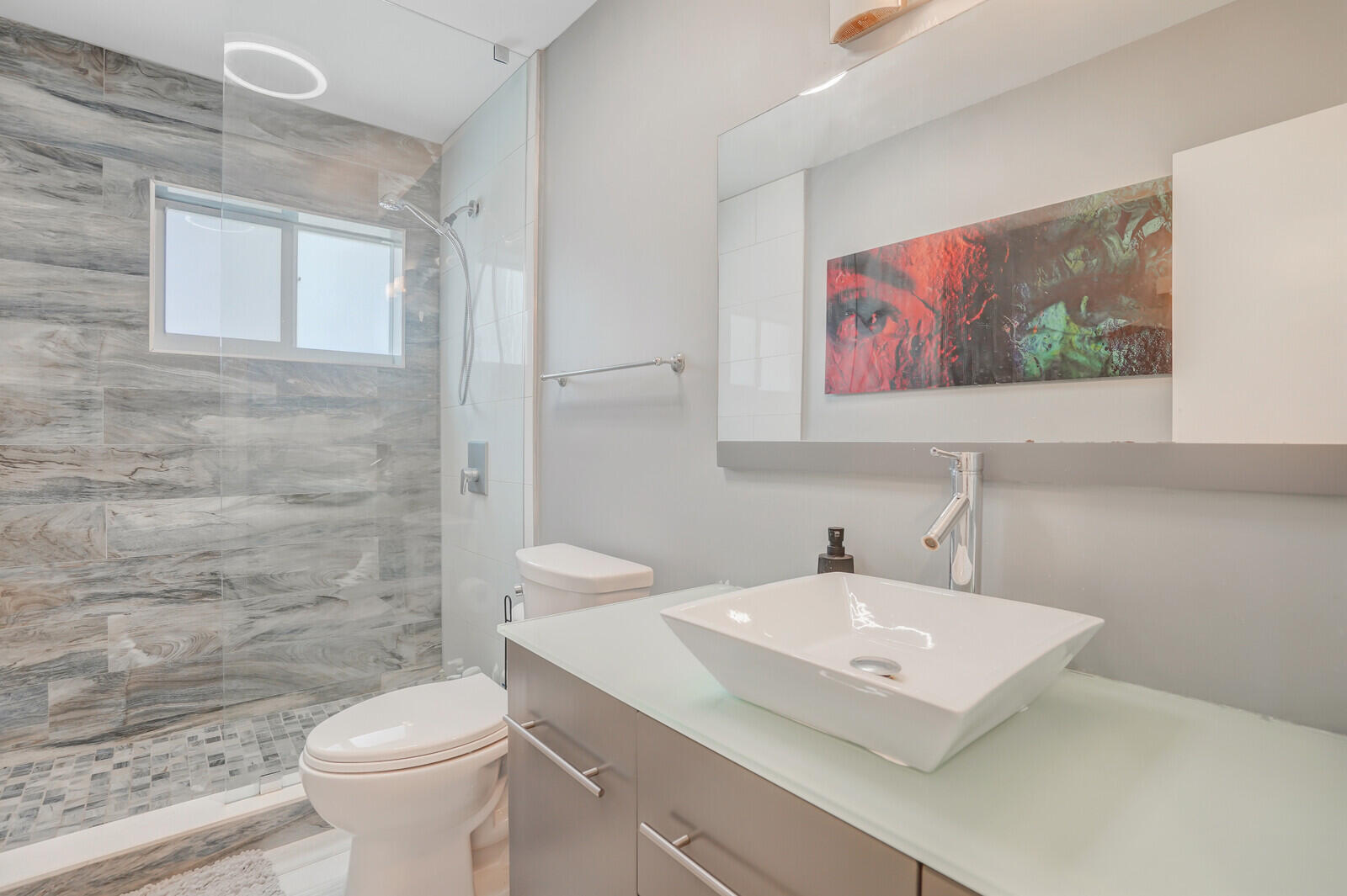 3098 Northeast 5th Avenue Boca Raton, FL 33431 - Photo 12 of 28 a bathroom with a sink a toilet and mirror