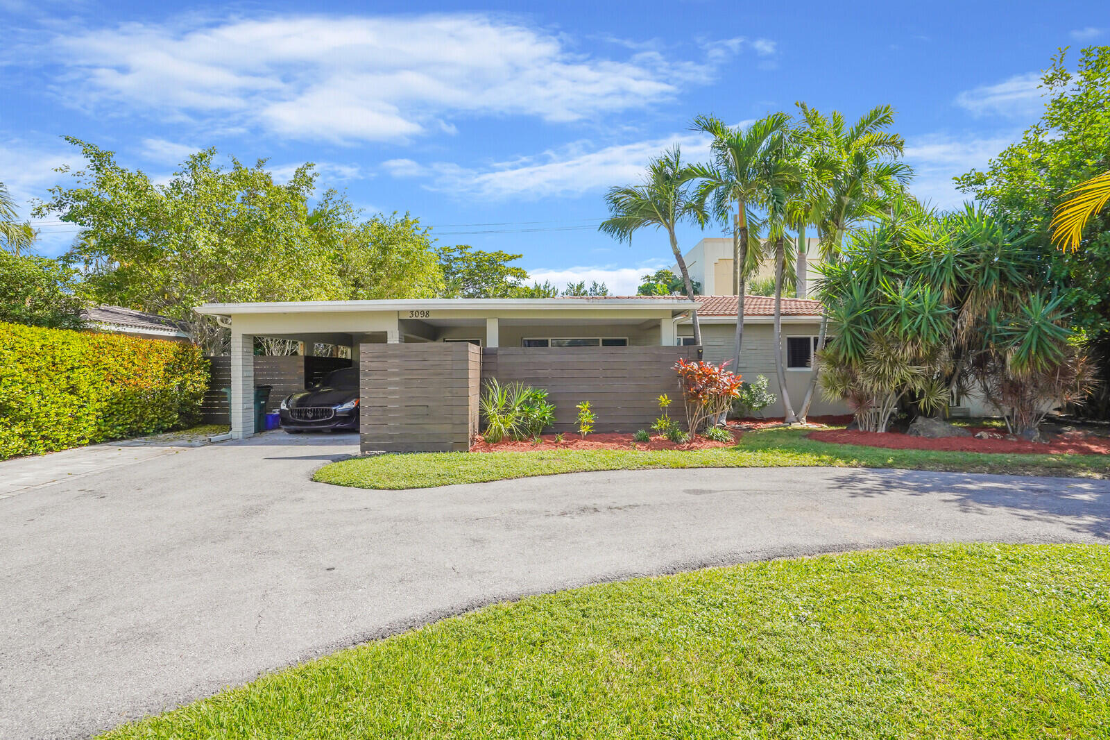 3098 Northeast 5th Avenue Boca Raton, FL 33431 - Photo 2 of 28 a front view of a house with porch and furniture