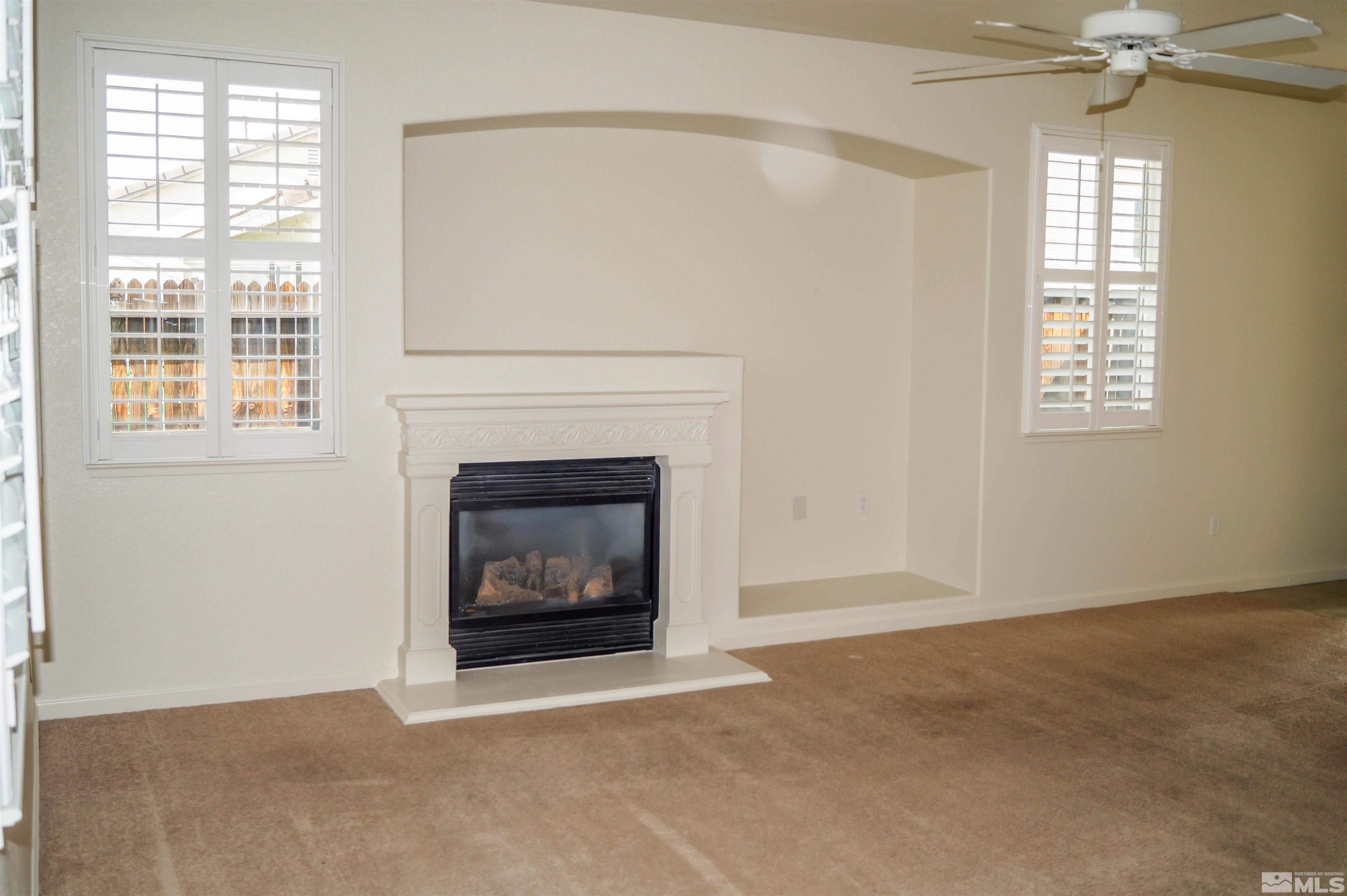1747 Canyon Shadow Circle Reno, NV 89521 - Photo 8 of 14 an empty room with windows and a fireplace