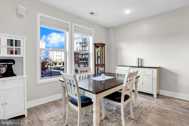 a view of a workspace with furniture and white kitchen