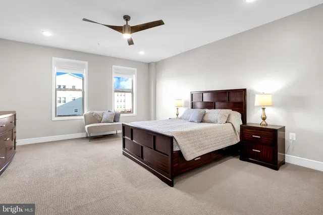 a bedroom with a bed and a ceiling fan