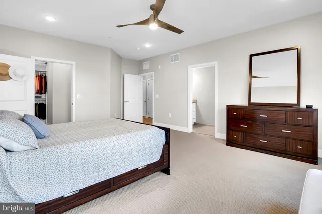 a bedroom with a bed and a dresser