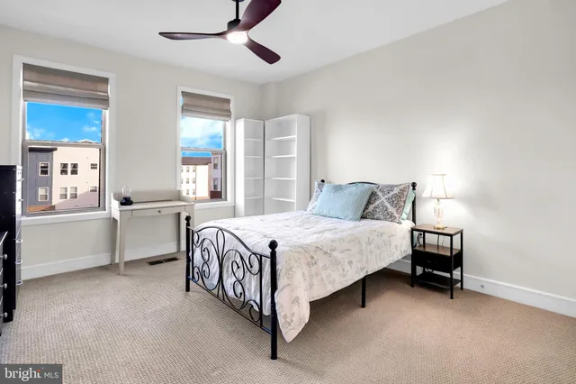 a spacious bedroom with a bed and a cabinets