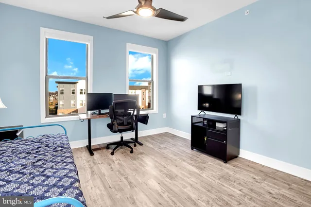 a view of a livingroom with workspace and a window