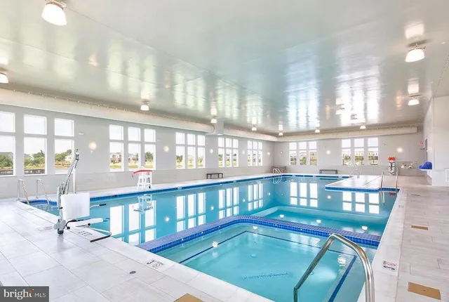 a view of a swimming pool kitchen outdoor seating and city view