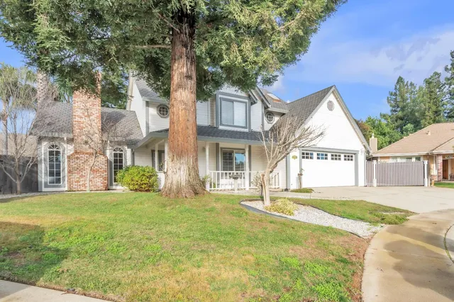 an empty room with a ceiling fan and window