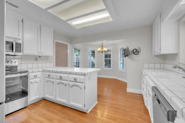 a view of an empty room with a fireplace and a window
