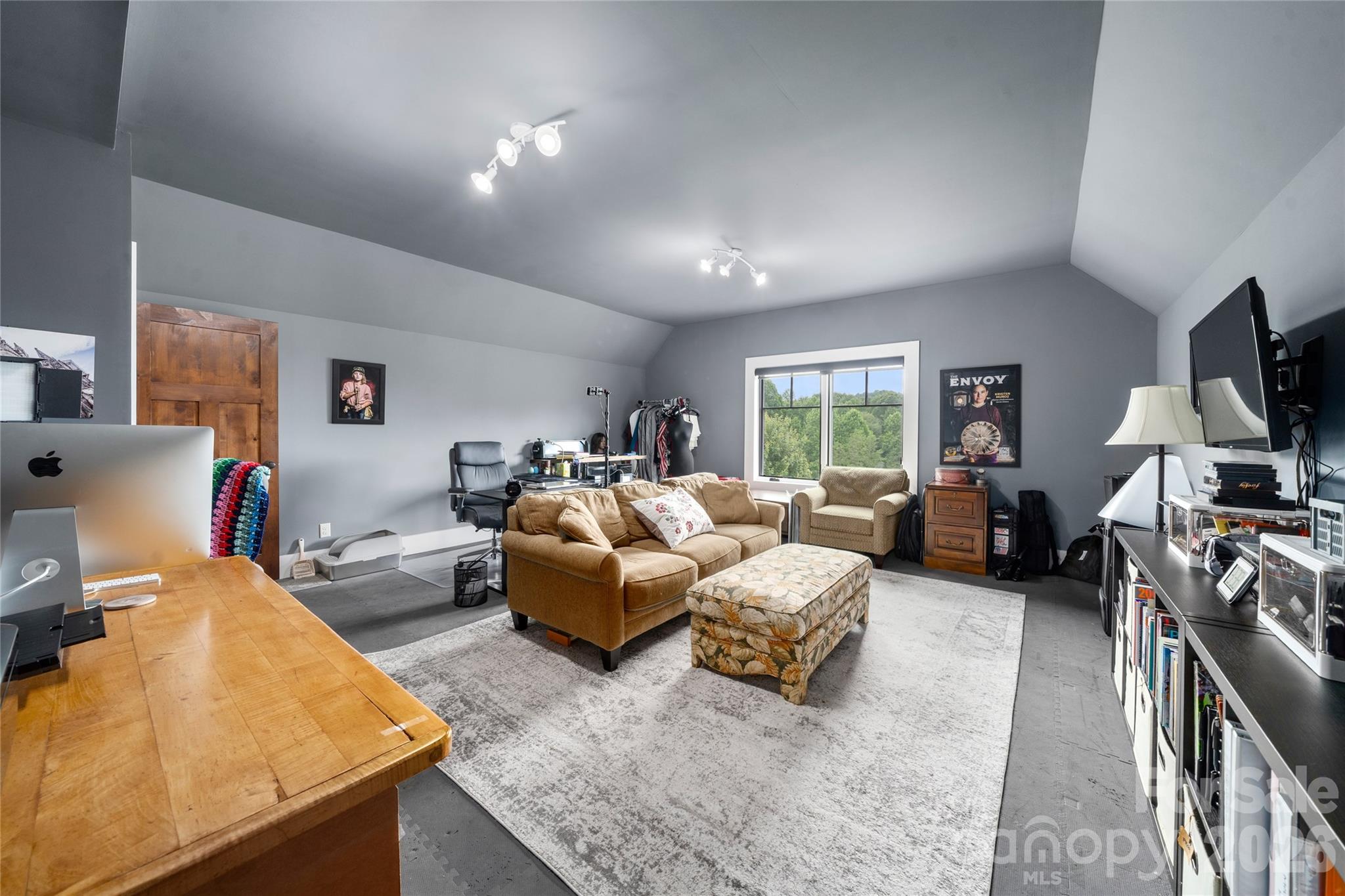 4862 Pinnacle Mountain Road Zirconia, NC 28790 - Photo 15 of 38 a living room with furniture flat screen tv and a large window