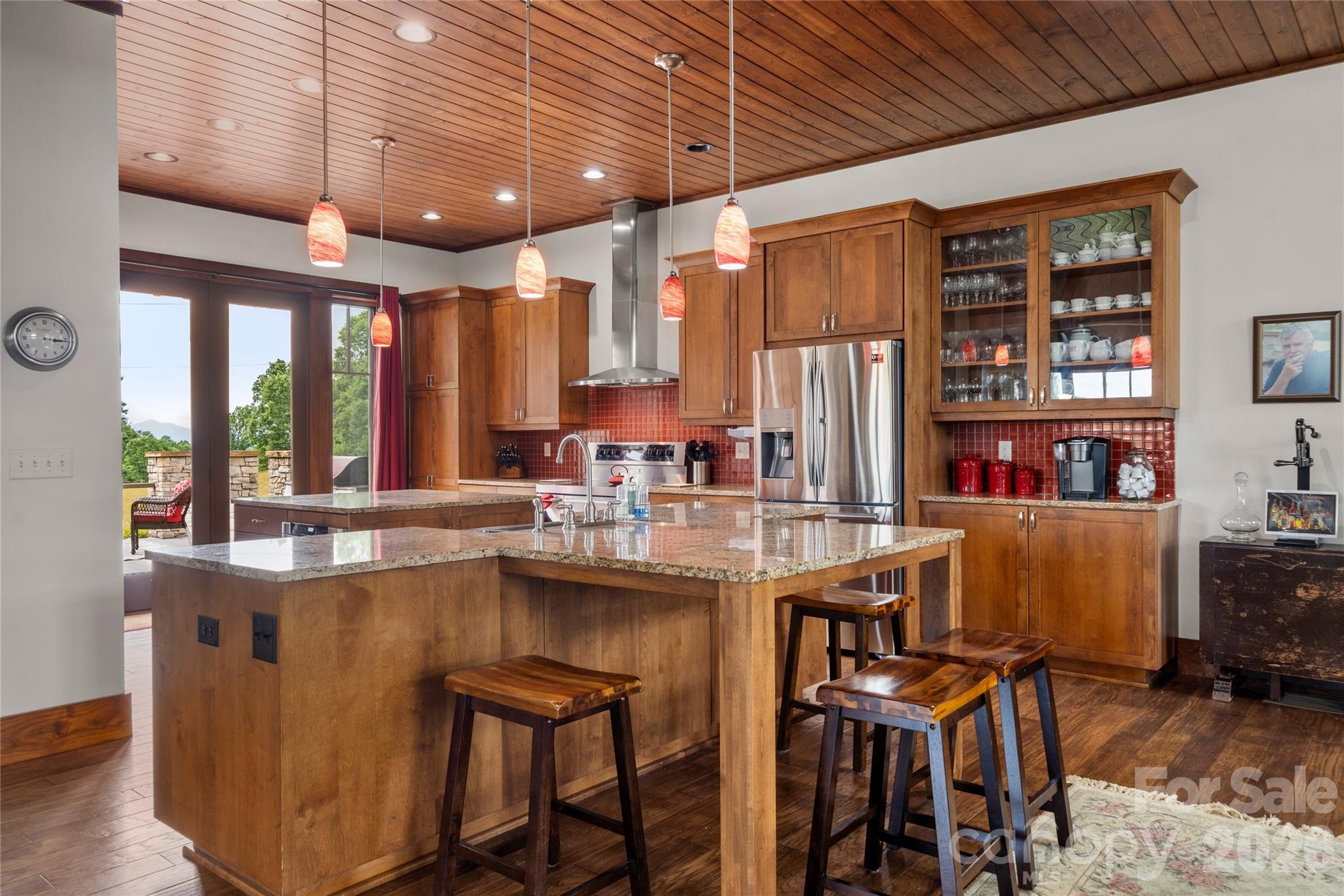 4862 Pinnacle Mountain Road Zirconia, NC 28790 - Photo 18 of 38 a kitchen with stainless steel appliances granite countertop a table chairs sink and cabinets