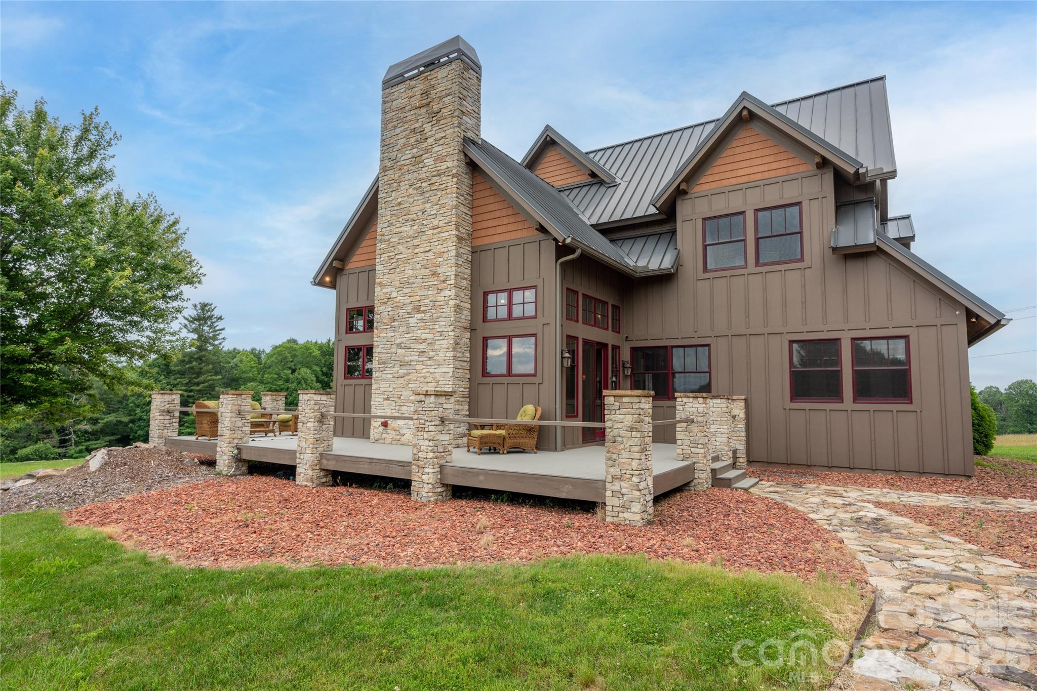 4862 Pinnacle Mountain Road Zirconia, NC 28790 - Photo 24 of 38 a view of a house with a yard and sitting area