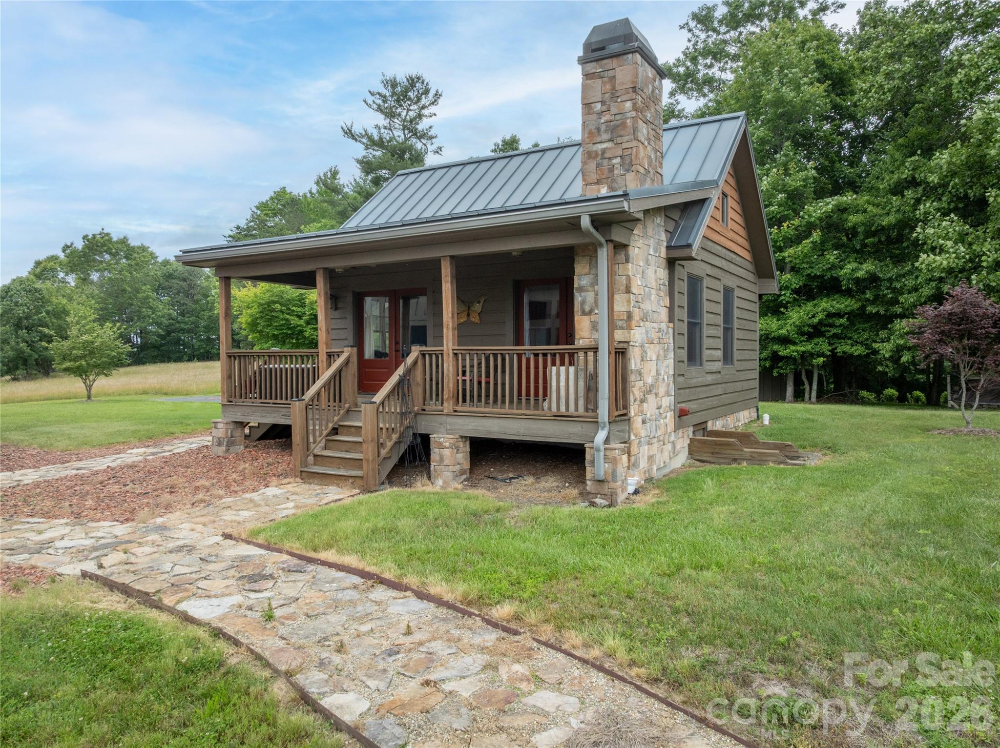 4862 Pinnacle Mountain Road Zirconia, NC 28790 - Photo 29 of 38 a view of a house with a yard and sitting area