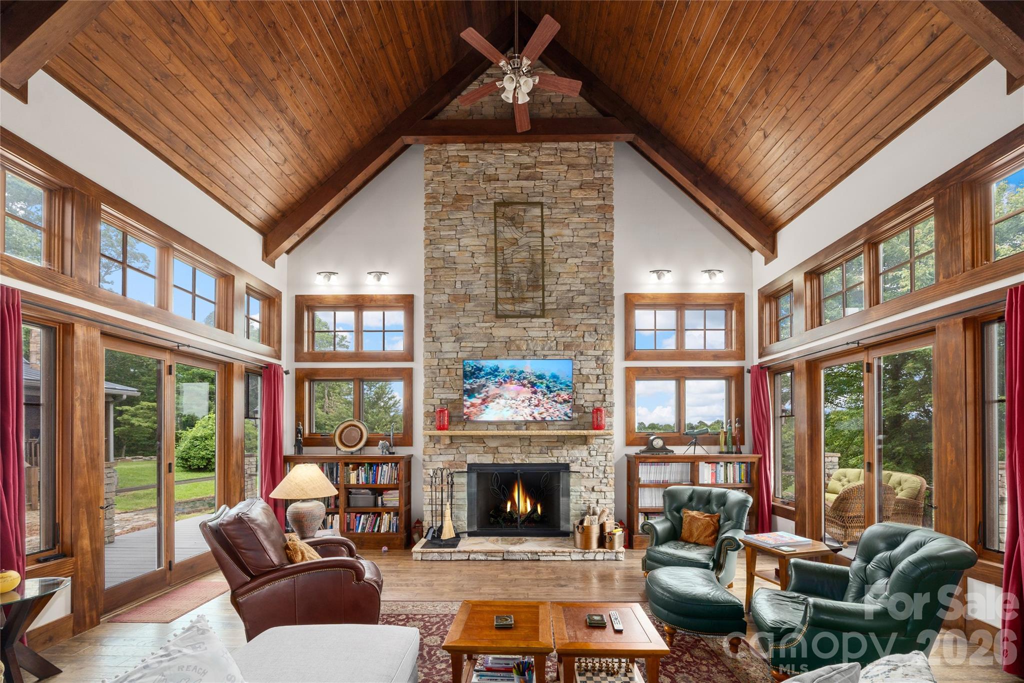 4862 Pinnacle Mountain Road Zirconia, NC 28790 - Photo 3 of 38 a living room with furniture a fireplace and floor to ceiling windows