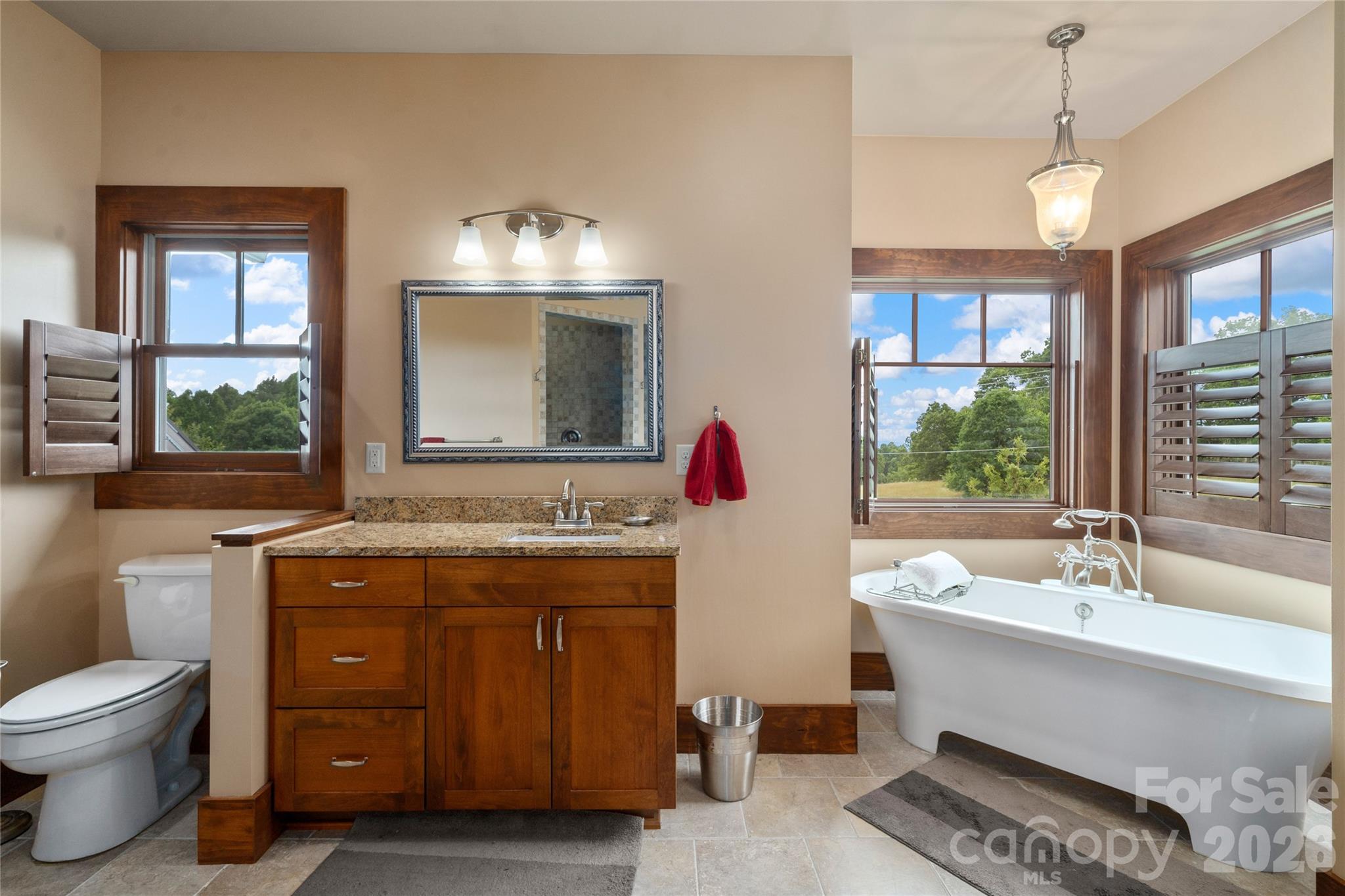 4862 Pinnacle Mountain Road Zirconia, NC 28790 - Photo 10 of 38 a spacious bathroom with a granite countertop sink and a mirror