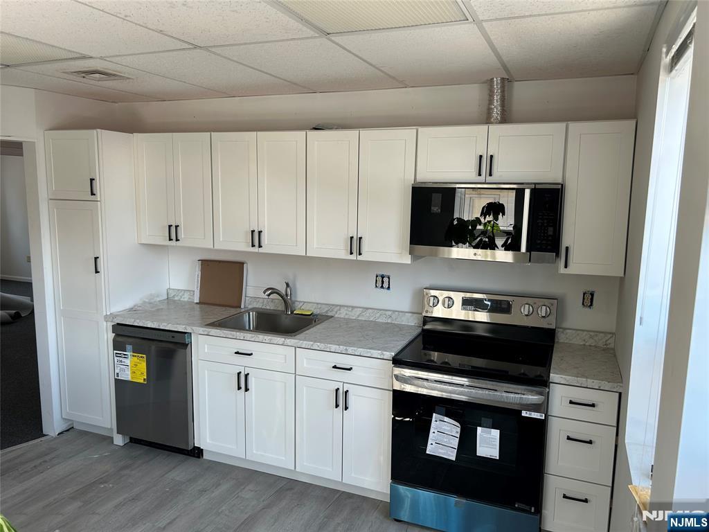 829 Main Street, Unit 2 Hackensack, NJ 07601 - Photo 1 of 8 a kitchen with stainless steel appliances a stove a sink and a refrigerator