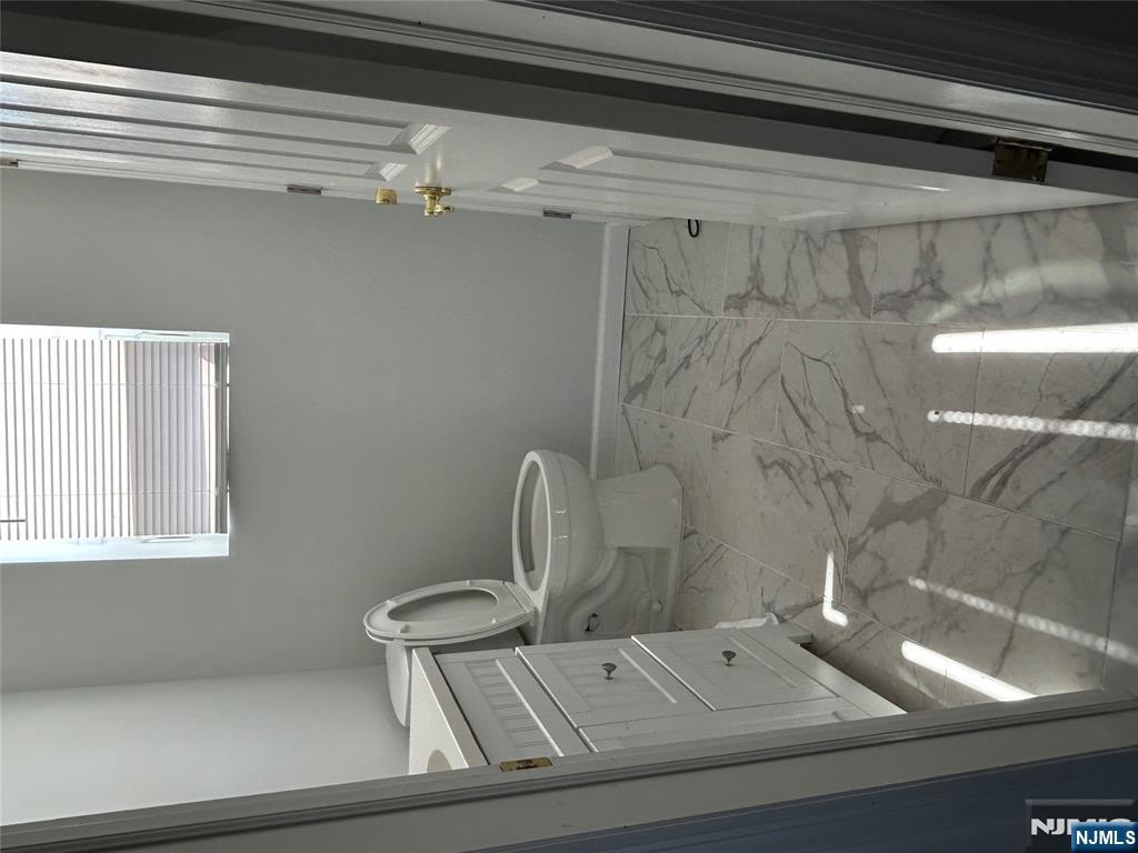 829 Main Street, Unit 2 Hackensack, NJ 07601 - Photo 3 of 8 a bathroom with a toilet and a shower