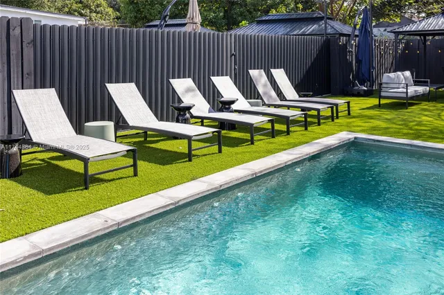 a large white bed sitting in a room next to a window