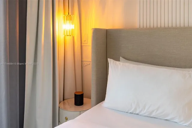 a view of a dining room with furniture a chandelier and wooden floor